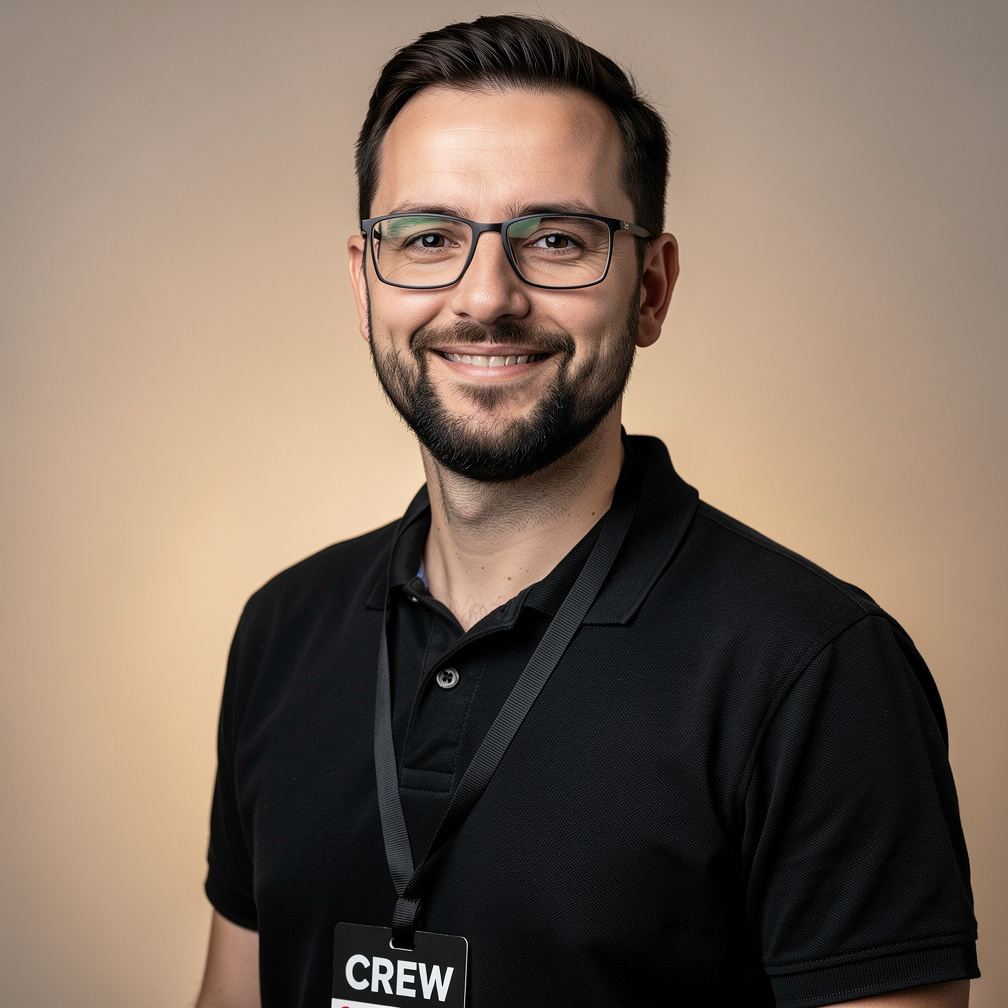 Studio portrait of a bearded man wearing glasses, a stage lighting technician